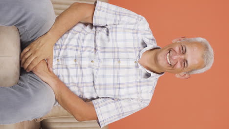 Vertical-video-of-The-man-waving-at-the-camera.